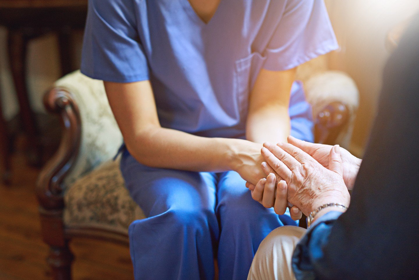 nurse holding patients hands